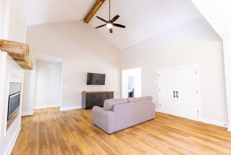 Spacious living room with vaulted ceiling and hardwood floor