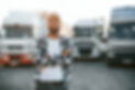 front-view-cap-young-truck-driver-is-with-his-vehicle-daytime.jpg