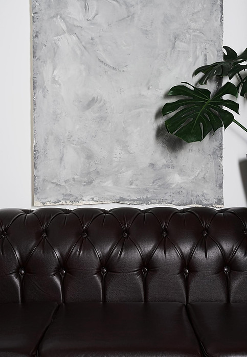 room-interior-details-with-comfortable-armchair-gray-tapestry-wall-vertical-frame.jpg