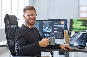 portrait-software-programmer-smiling-camera-while-posing-workplace-office-with-coffee-cu.j