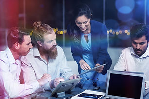 businesswoman-discussing-with-colleagues-digital-tablet.jpg