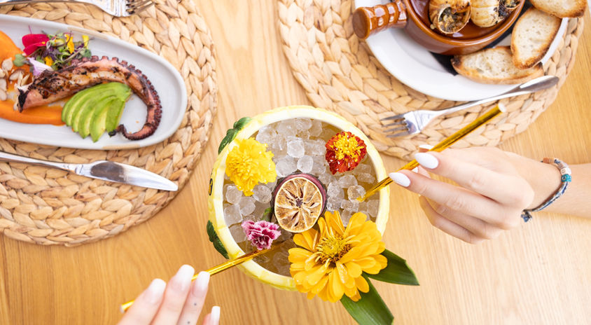 Cocktail served with an octopus and escargot dish
