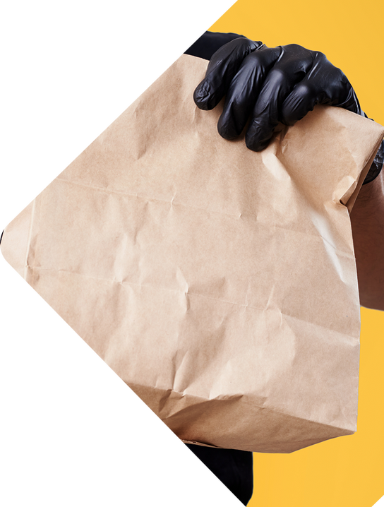 courier-black-uniform-holds-paper-bag-yellow-background.png