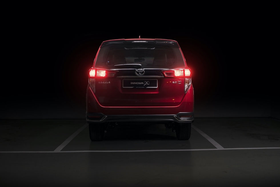 crimson-spark-red-metallic-toyota-innova-mpv-back-view-in-dark-room