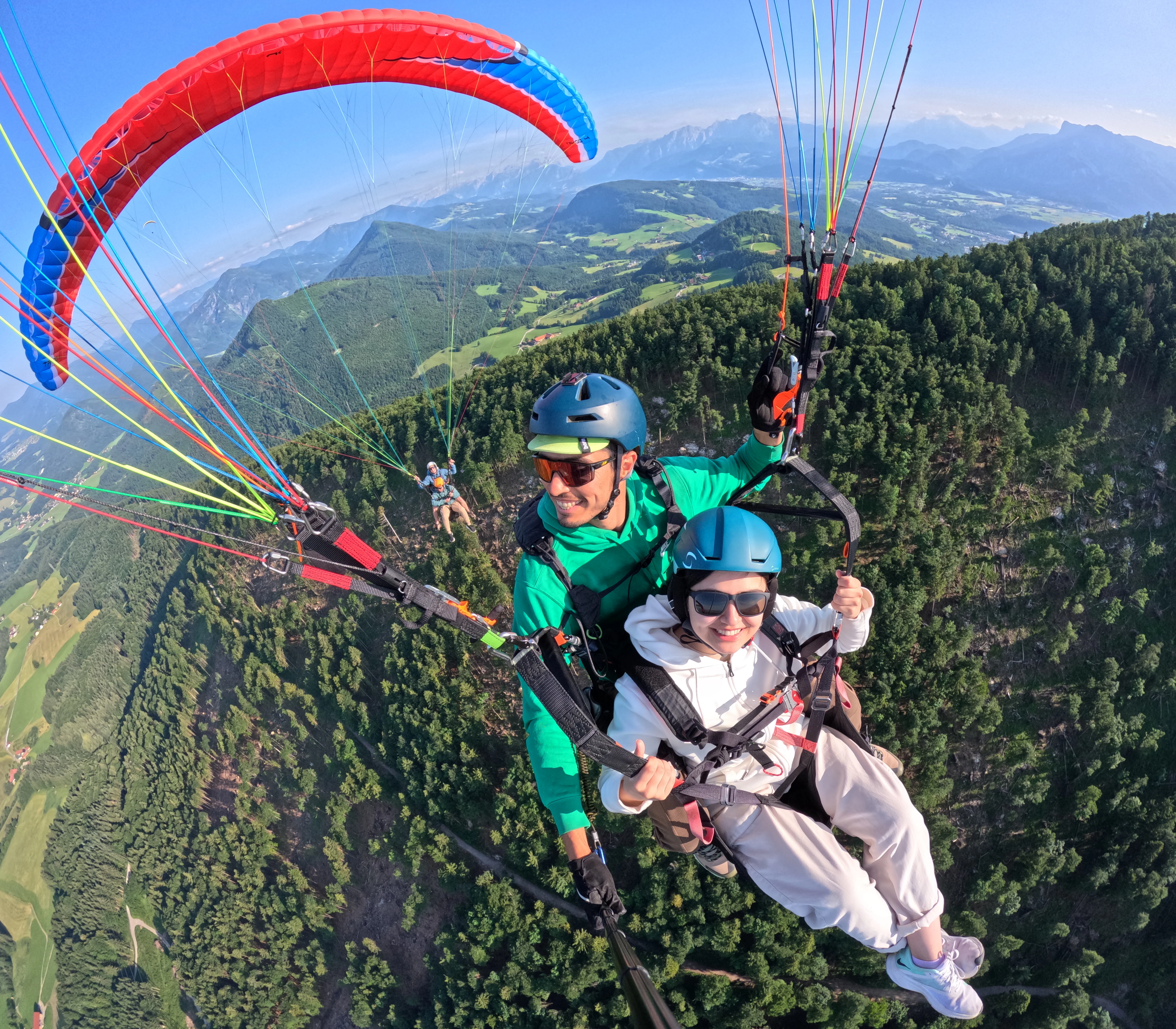Tandem paragliders above Gaisberg with Salzkammergut landscape