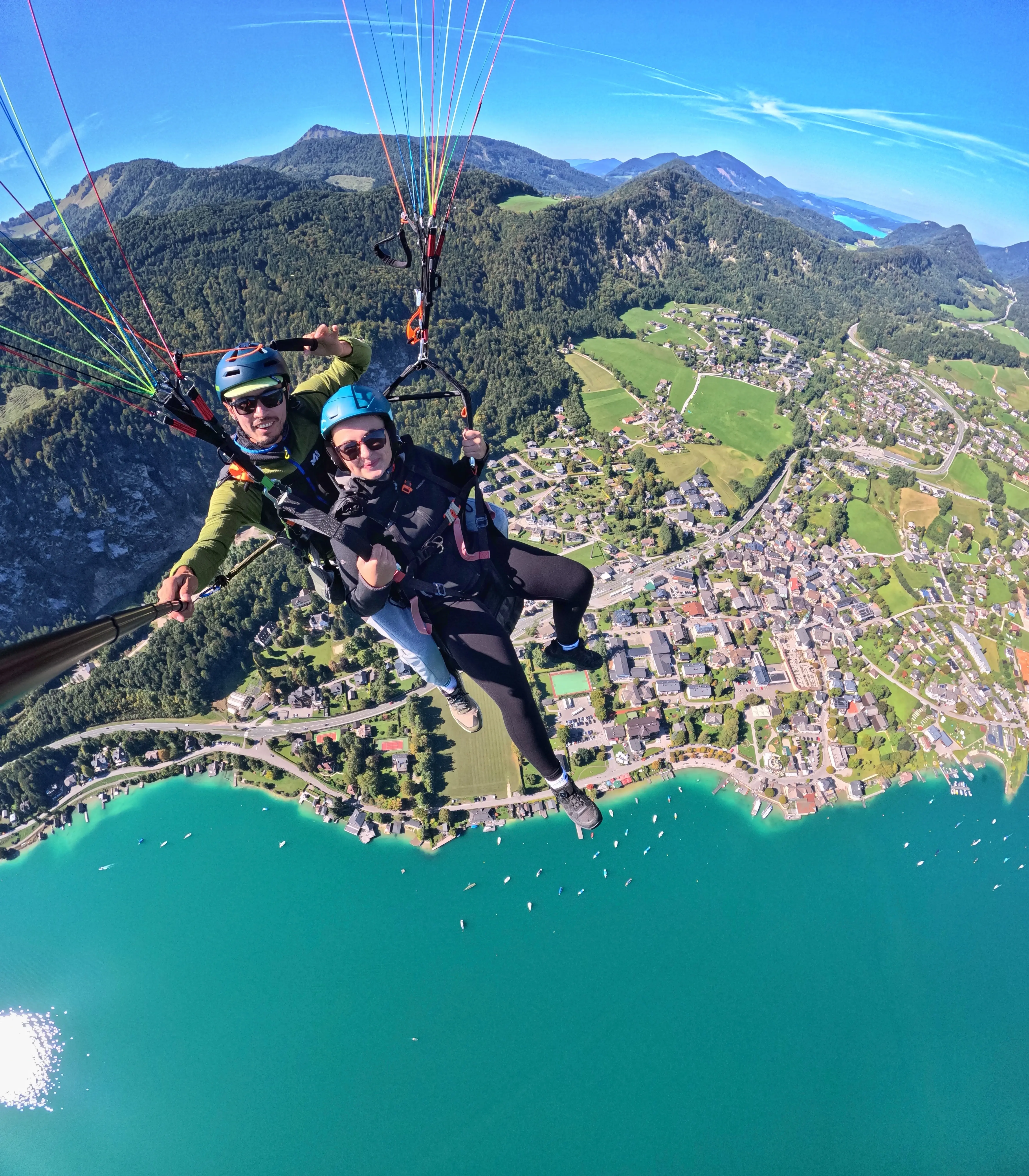 A Paragliding soaring with Alps mountain in the background