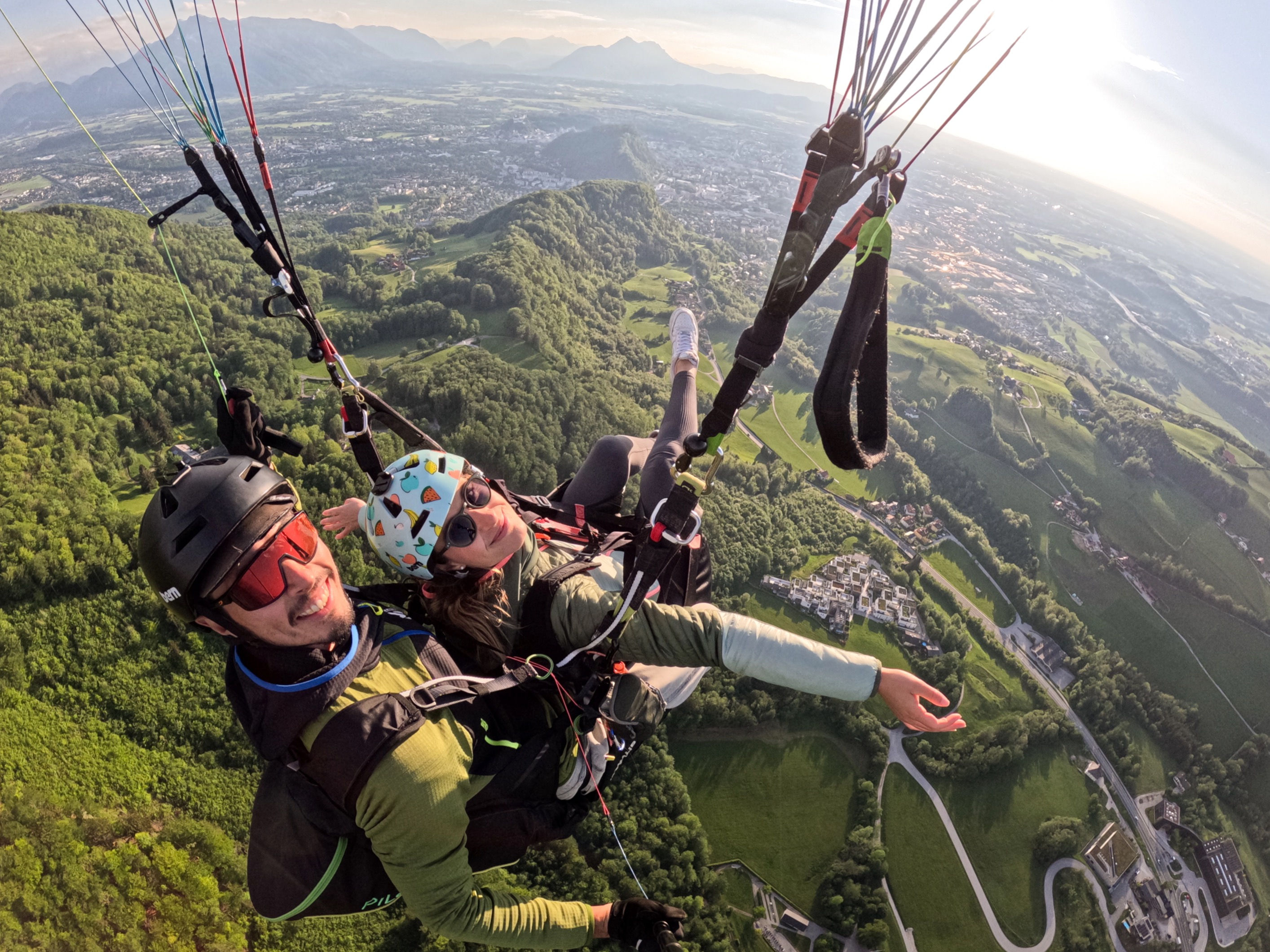 Winter Tandem Paragliding takeoff from snow-capped Gaisberg. Panoramic view towards Untersberg mountain and Salzburg Alps.
