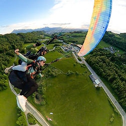 Action Tandem Paragliding over the landing field in Guggenthal, Salzburg and the Wolfgangsee Street.