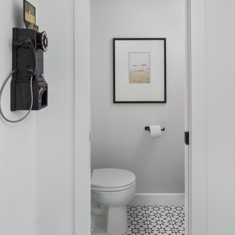 powder room with black and white patterned tile floor