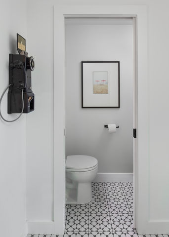powder room with black and white patterned tile floor