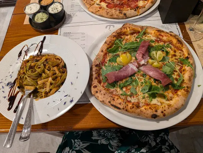 Truffle pasta and prosciutto pizza served together at Pizza Pasta Tudors in Split.