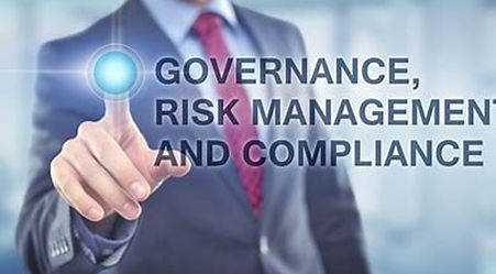 Business man pointing to words that say governance, risk management, and compliance