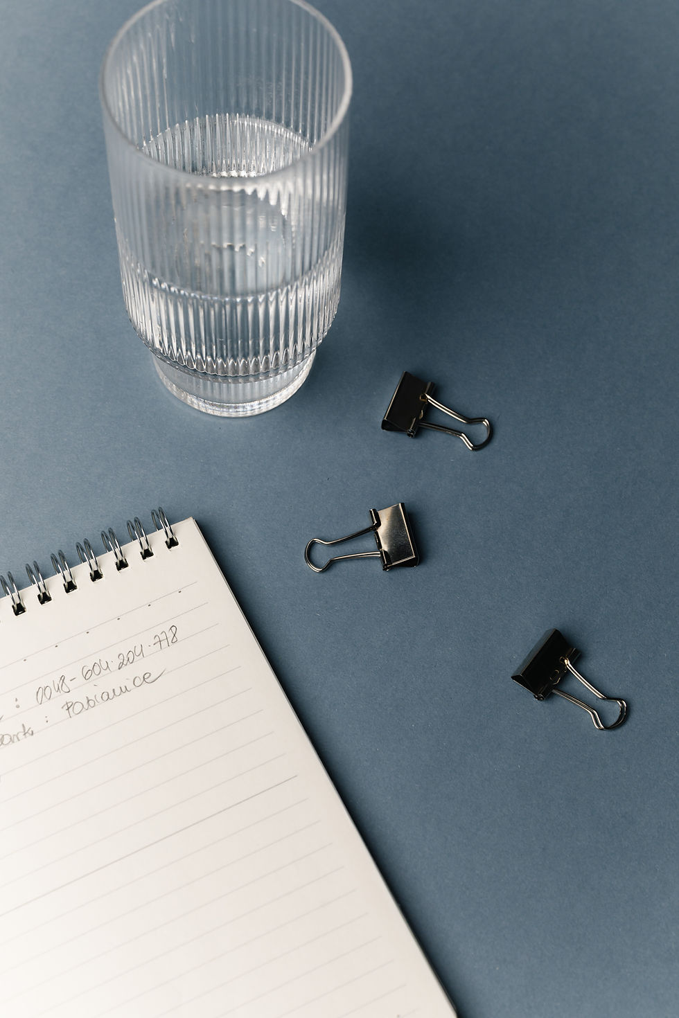 kaboompics_workspace-flat-lay-with-notebook-glass-and-office-clips-41966.jpg