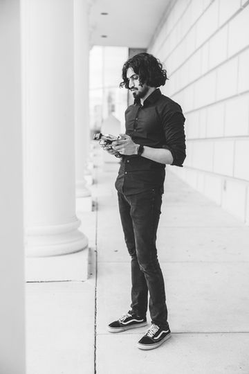 Black and white photo of Shahameer holding a professional camera