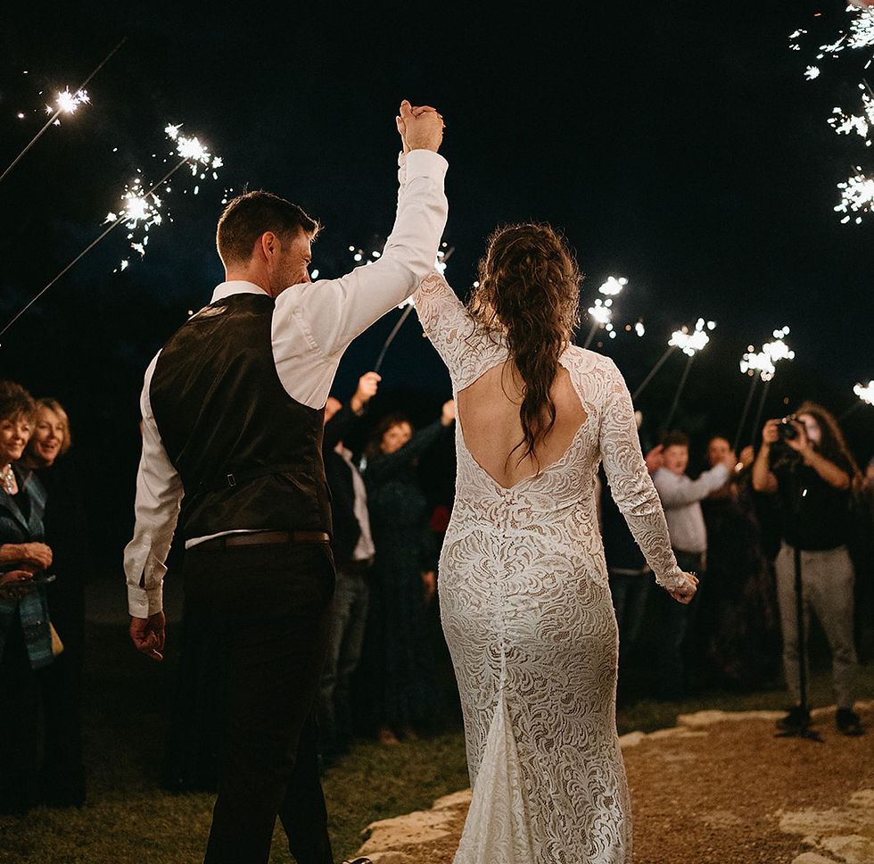 Bride and groom wave to guests of honor