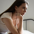 anxious-woman-bed-side-view.jpg