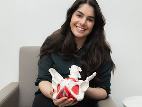 pelvic floor physiotherapist holding a female pelvic floor anatomy model