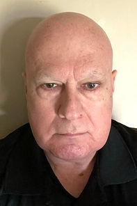 Sam Frisone, a bald white man. He is wearing a black shirt.
