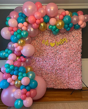 pink and blue balloon arch and photo backdrop for baby shower
