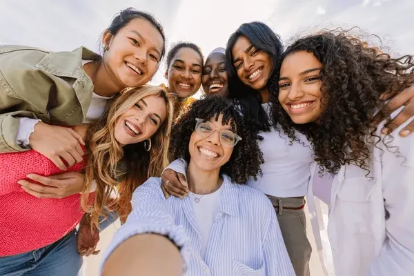a diverse group of teen girls smiling