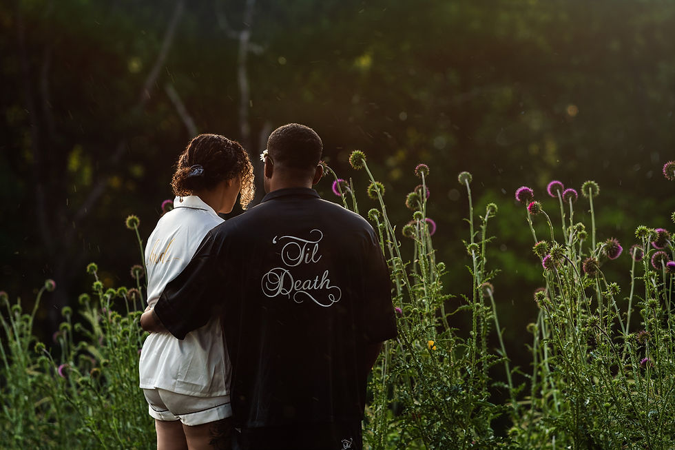 Couple embracing in a wildflower field during an intimate elopement in Branson, Missouri.