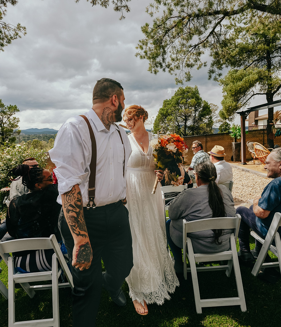 Bride and groom walk back down the aisle together after their intimate outdoor wedding ceremony in Prescott, Arizona.