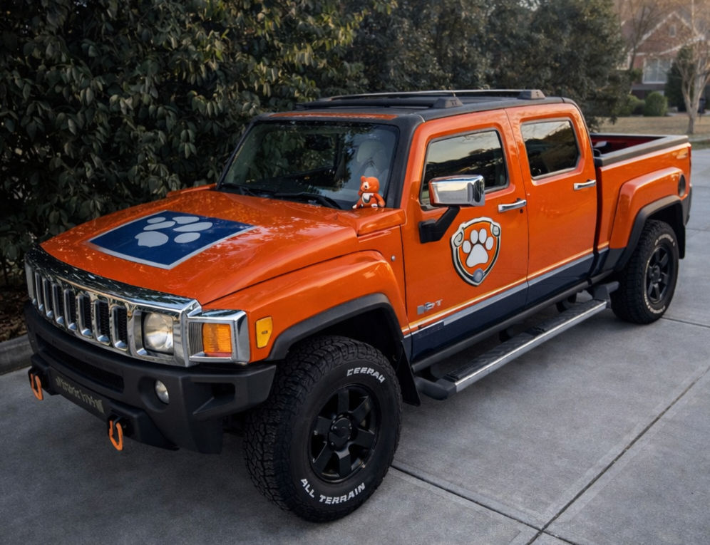 Orange Water Dog Rig Hummer H3T with paw patrol prints