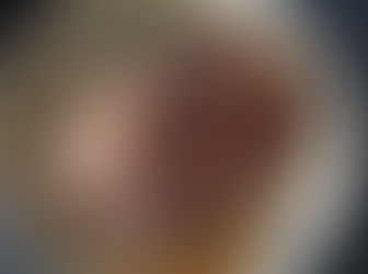 Trussed and seared pork with whole black peppercorns and rosemary braising in liquid in a large pot. Juicy and browned with herbs visible, creating a warm and savoury atmosphere. The setting is a stove top. 