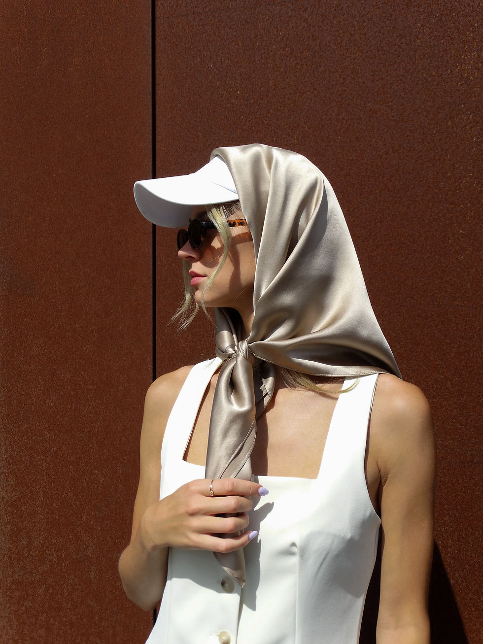 woman styling a silk scarf as a headband with loose hair