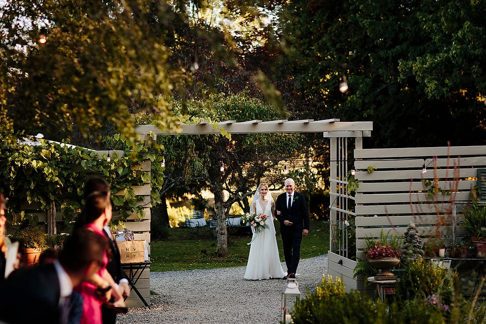 bride and dad entering wedding ceremony in nature background