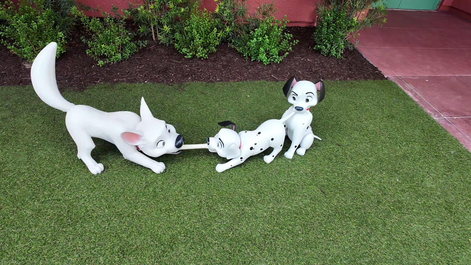 Character figures on the lawn outside the building.