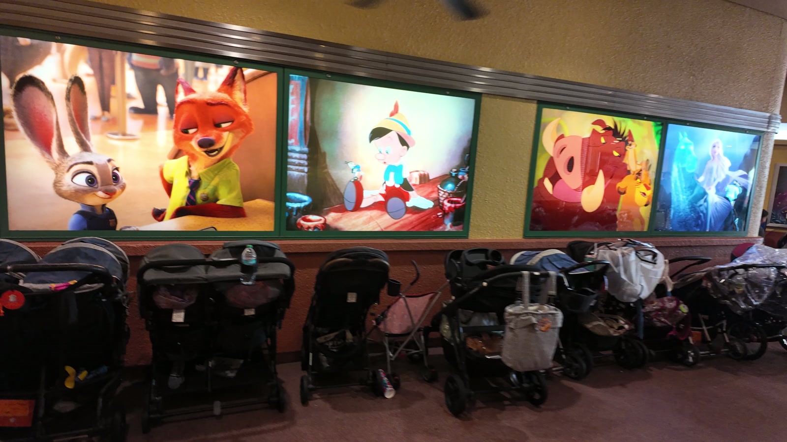 Strollers parked along a covered walkway near The Magic of Disney Animation.