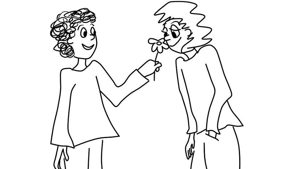 kid smelling a flower given by another