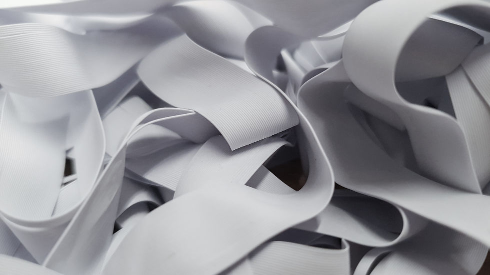 Pile of white rubber threads stacked on top of each other