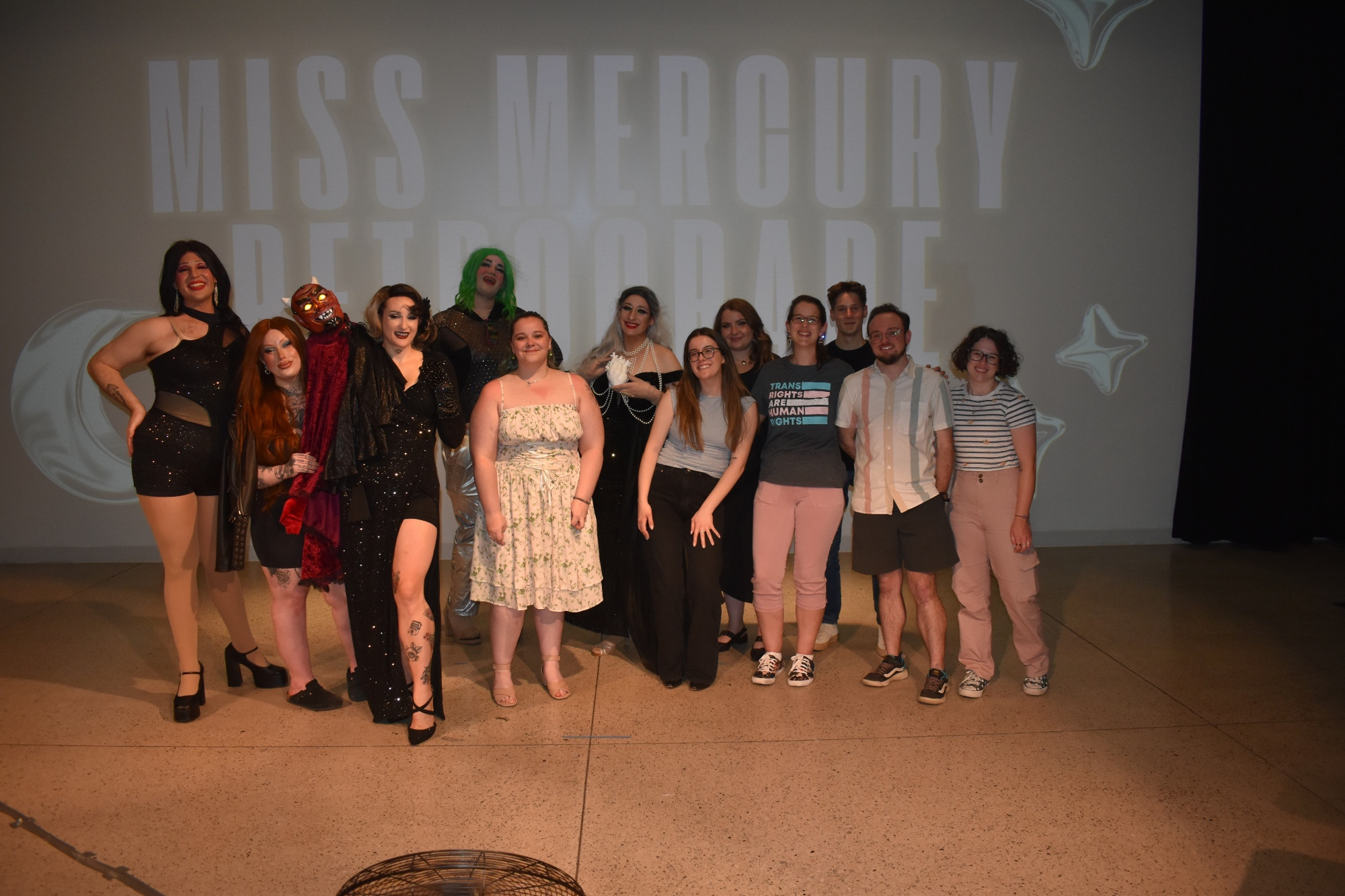 A group of researchers is pictured alongside multiple drag performers