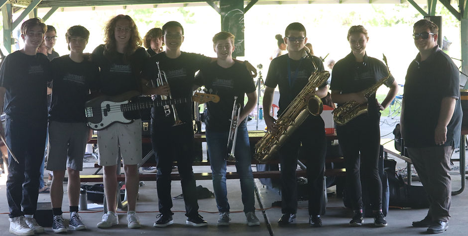 musicians standing together with their instruments