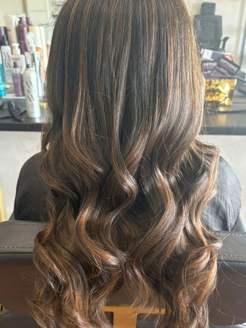 Soft caramel tones and glossy waves.