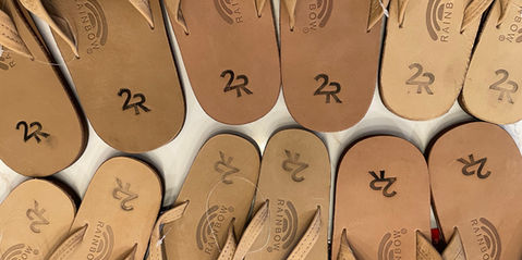 A company Christmas gift of hand-stamped sandals with the new logo design.