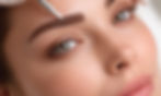 Woman receiving microblading treatment