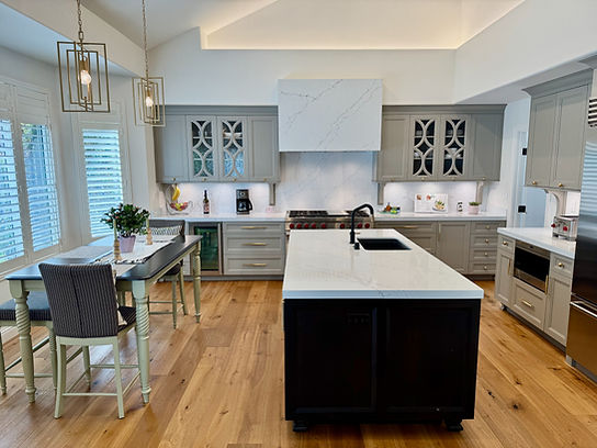 Modern kitchen with island, cabinets, countertops, and appliances; kitchen remodel