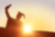 Silhouette of graduate against sun shining.jpg