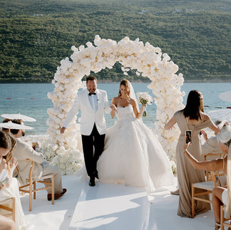 Celebrity bride Nadja Kljajic and groom walking back down the aisle at One&Only Portonovi Montenegro just before confetti celebration – luxury editorial wedding photography by Montenegro wedding photographer
