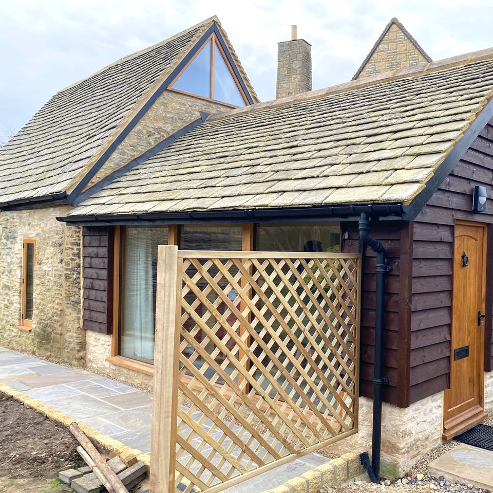 Stone barn extension with timber cladding.