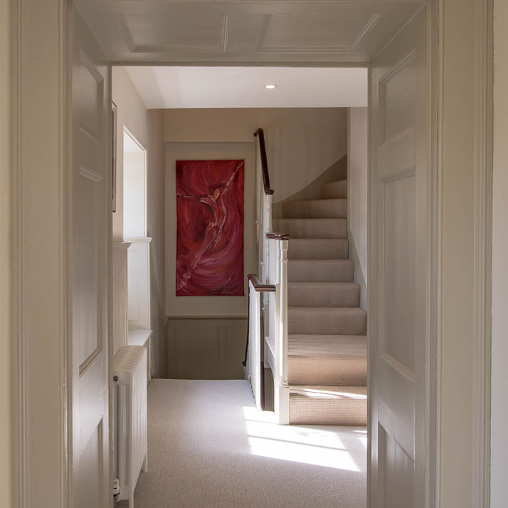 Interior of period property looking along landing to stair.