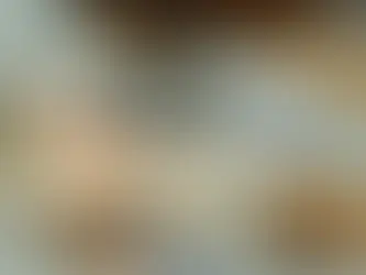 Calculator on financial documents, surrounded by euro banknotes. The setting suggests an office environment focused on finances.