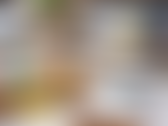 A well-organized desk set up for bookkeeping cleanup, featuring stacked binders labeled by year (2022, 2023, 2024), an accordion file filled with categorized receipts, sticky notes marked “Taxes” and “Old Receipts,” a magnifying glass resting on financial reports with colorful bar charts, a calculator, a laptop displaying graphs, and neatly stacked paperwork on a wooden desk.