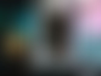 Man in yellow beanie receiving food from a truck window. Neon "OPEN" sign glows pink in the background, creating a welcoming atmosphere.