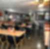 The interior of Silverado's is pictured - the diner is filled with tables and chairs and a concrete floor.