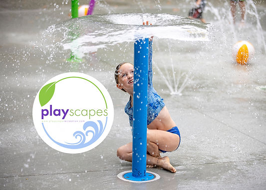 A girl is shown playing under a water play feature. She's smiling and running her hand through the fountain of water. There is a beach ball in the background. The Playscapes logo is shown, with a green leaf accent and a light blue wave accent.