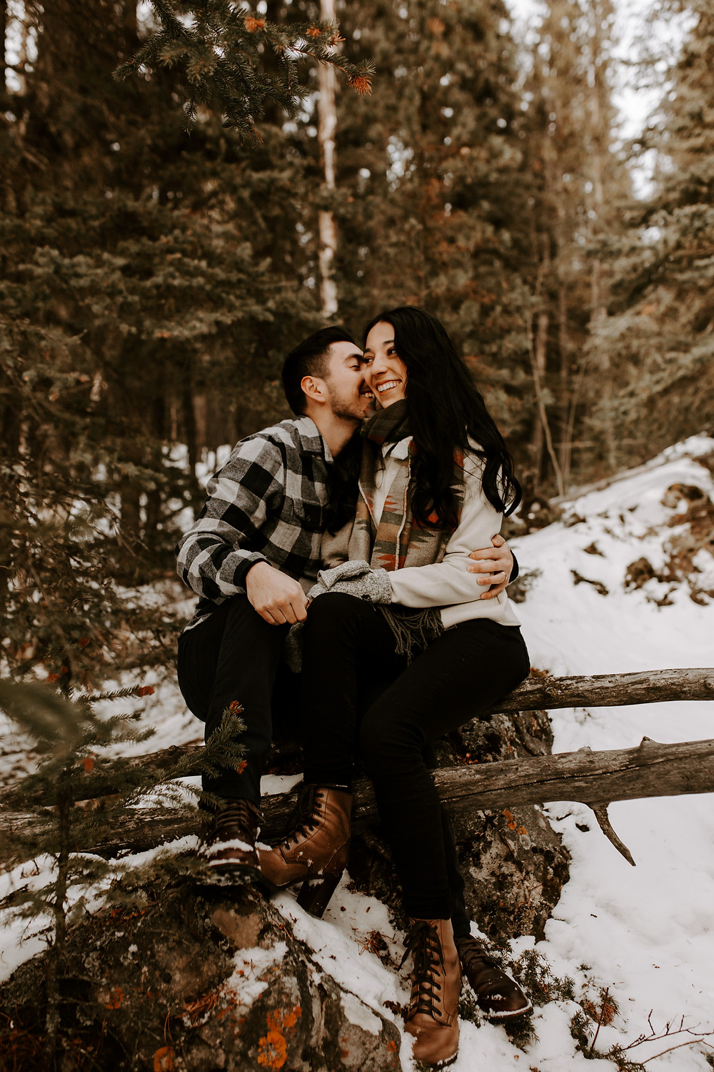 couple whispering lake minnewanka